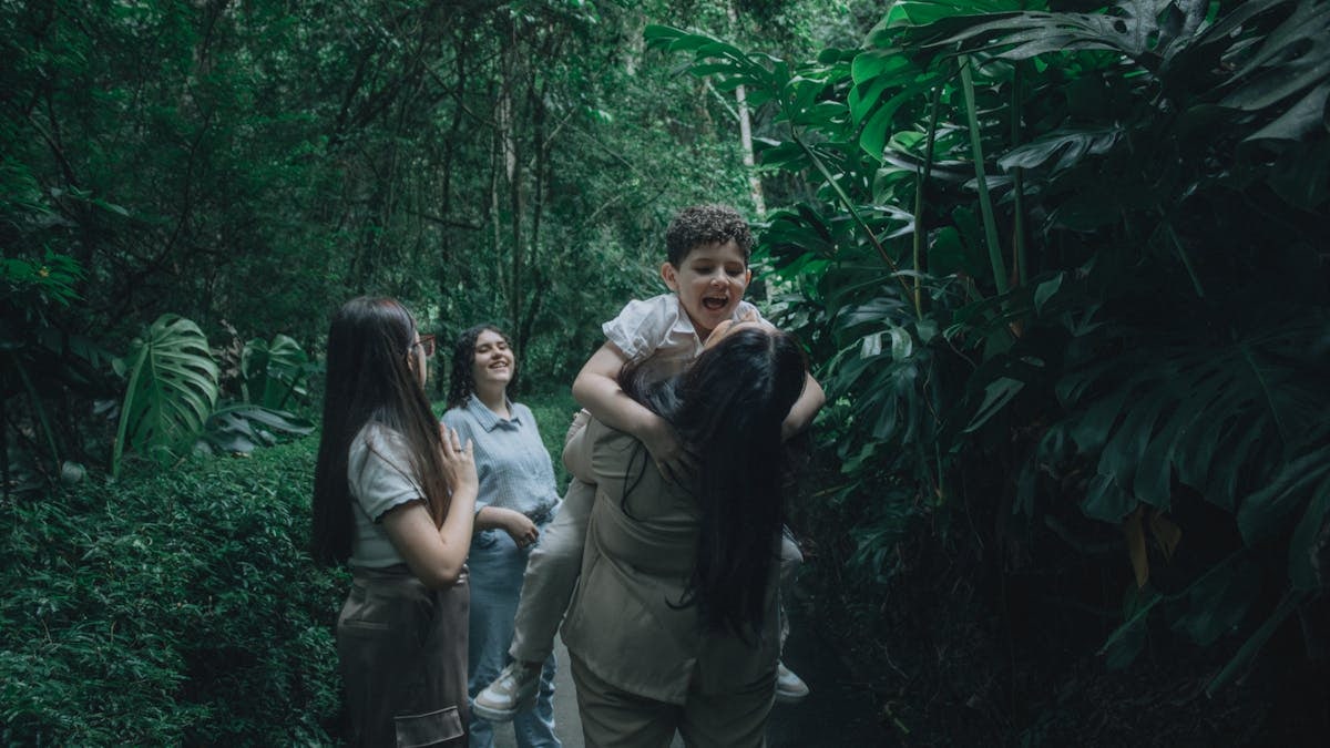 A joyful family bonding in a lush green forest, embracing nature.
